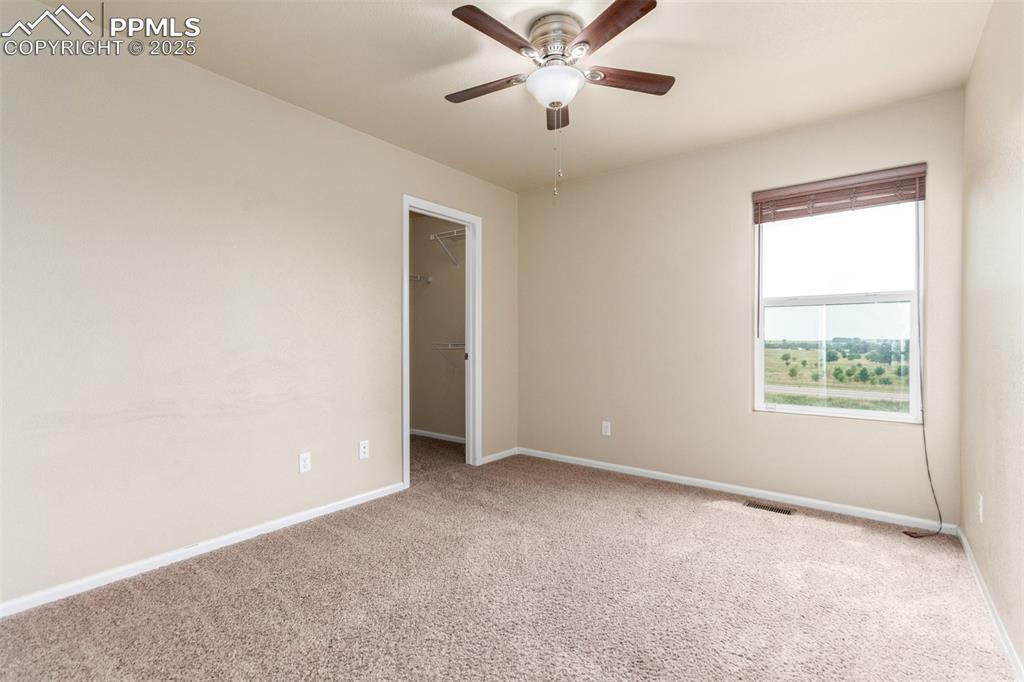 7750 Dutch Loop Colorado Springs, CO 80925 - Photo 29 of 50 an empty room with a window and a fan