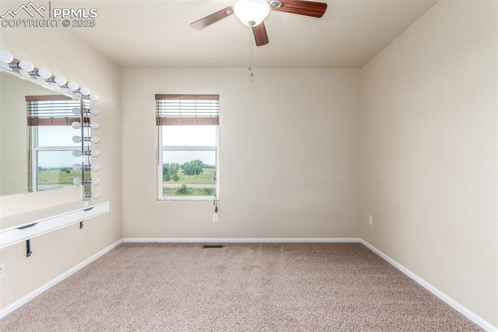 7750 Dutch Loop Colorado Springs, CO 80925 - Photo 32 of 50 wooden floor in an empty room with a window