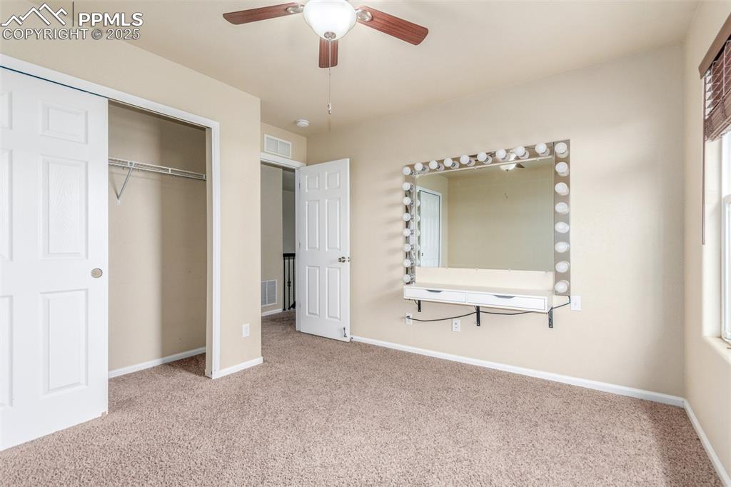7750 Dutch Loop Colorado Springs, CO 80925 - Photo 33 of 50 a view of a livingroom with a cabinet and chandelier