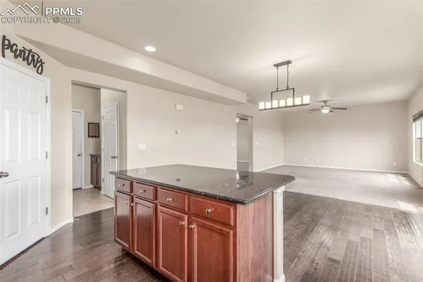 a view of a kitchen with a sink and chandelier