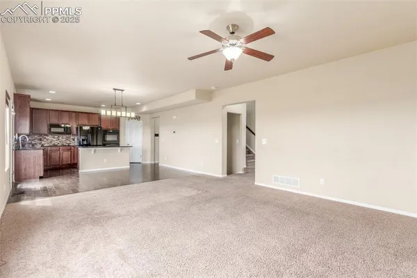 a view of a kitchen with a sink and microwave
