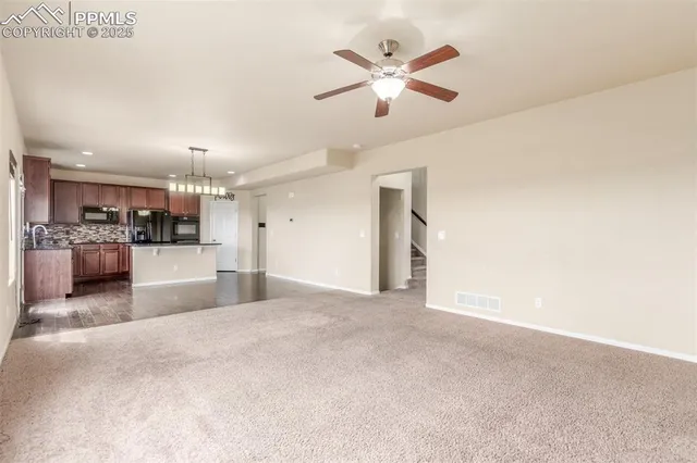 a view of a kitchen with a sink and microwave