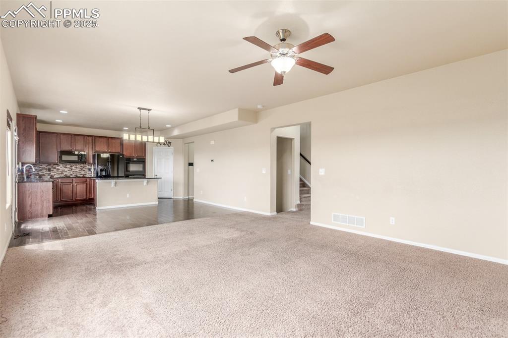 7750 Dutch Loop Colorado Springs, CO 80925 - Photo 10 of 50 a view of a kitchen with a sink and microwave