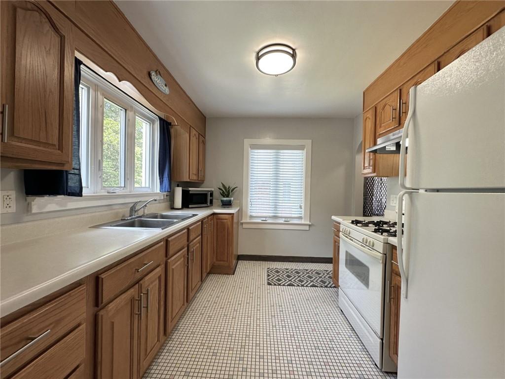 1804 River Road North Apollo, PA 15673 - Photo 16 of 39 a kitchen with a stove a sink and a refrigerator