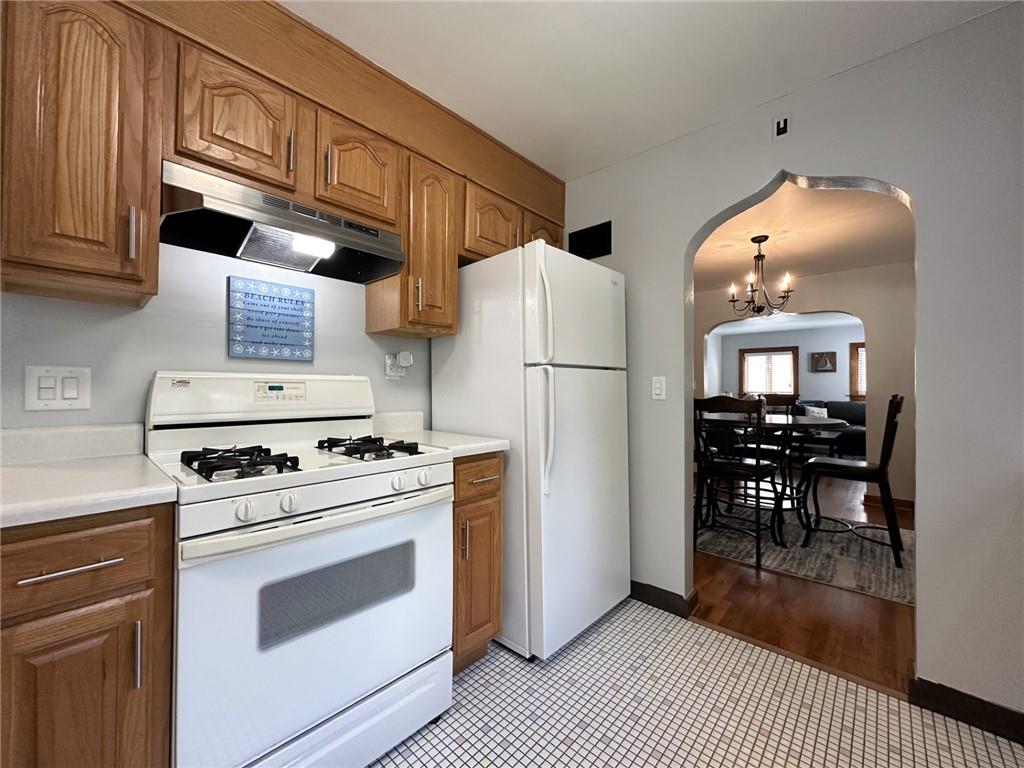 1804 River Road North Apollo, PA 15673 - Photo 17 of 39 a kitchen with a refrigerator a stove and a dining table with wooden floor