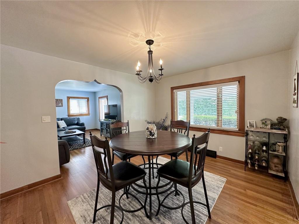 1804 River Road North Apollo, PA 15673 - Photo 21 of 39 a dining room with wooden floor a chandelier a wooden table and chairs