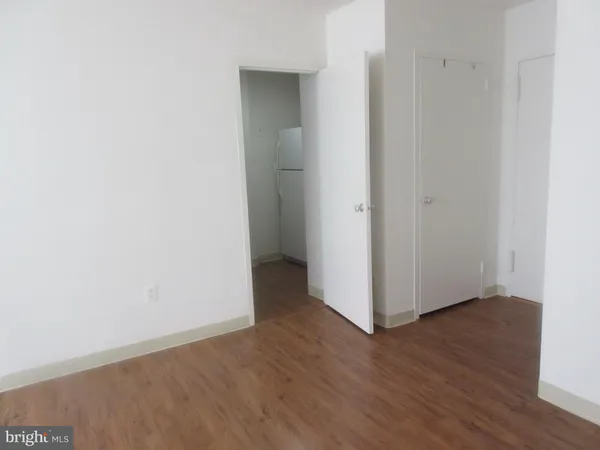 a view of staircase with wooden floor and a chair