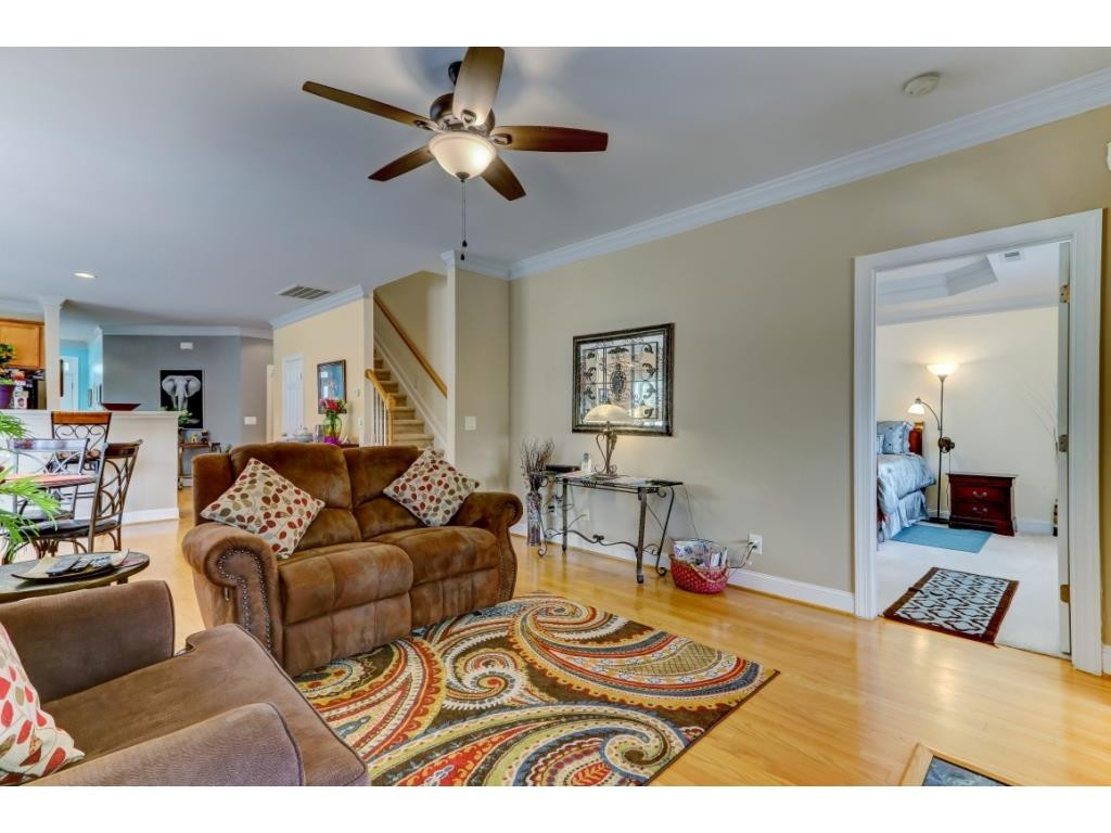 217 Eva Drive Gibsonville, NC 27249 - Photo 12 of 24 a living room with furniture and a wooden floor