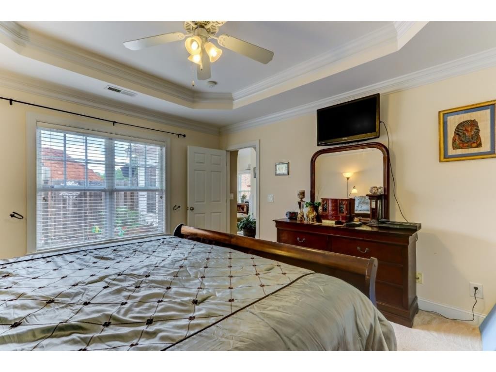 217 Eva Drive Gibsonville, NC 27249 - Photo 17 of 24 a bedroom with a bed and a chandelier