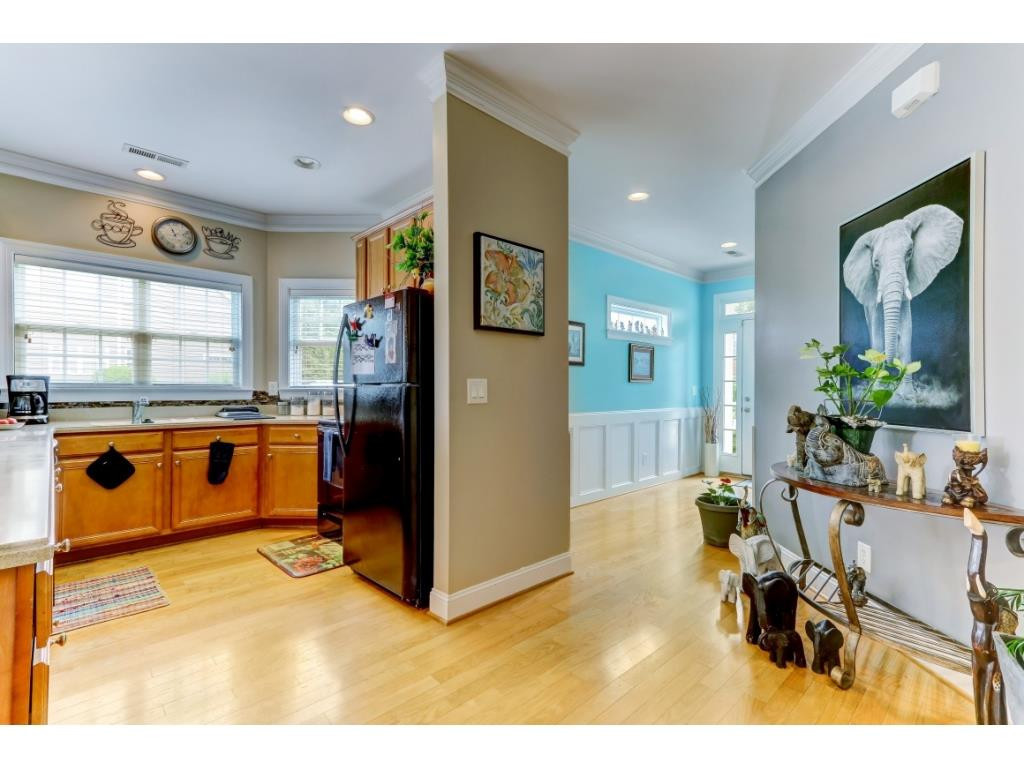 217 Eva Drive Gibsonville, NC 27249 - Photo 6 of 24 a kitchen with stainless steel appliances kitchen island granite countertop a refrigerator and cabinets