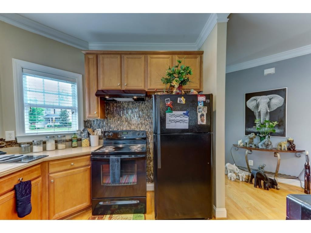 217 Eva Drive Gibsonville, NC 27249 - Photo 7 of 24 a kitchen with stainless steel appliances granite countertop a stove a sink and a refrigerator