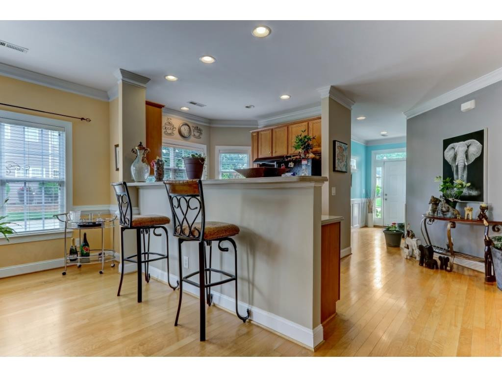 217 Eva Drive Gibsonville, NC 27249 - Photo 8 of 24 a view of a dining room kitchen with furniture and wooden floor