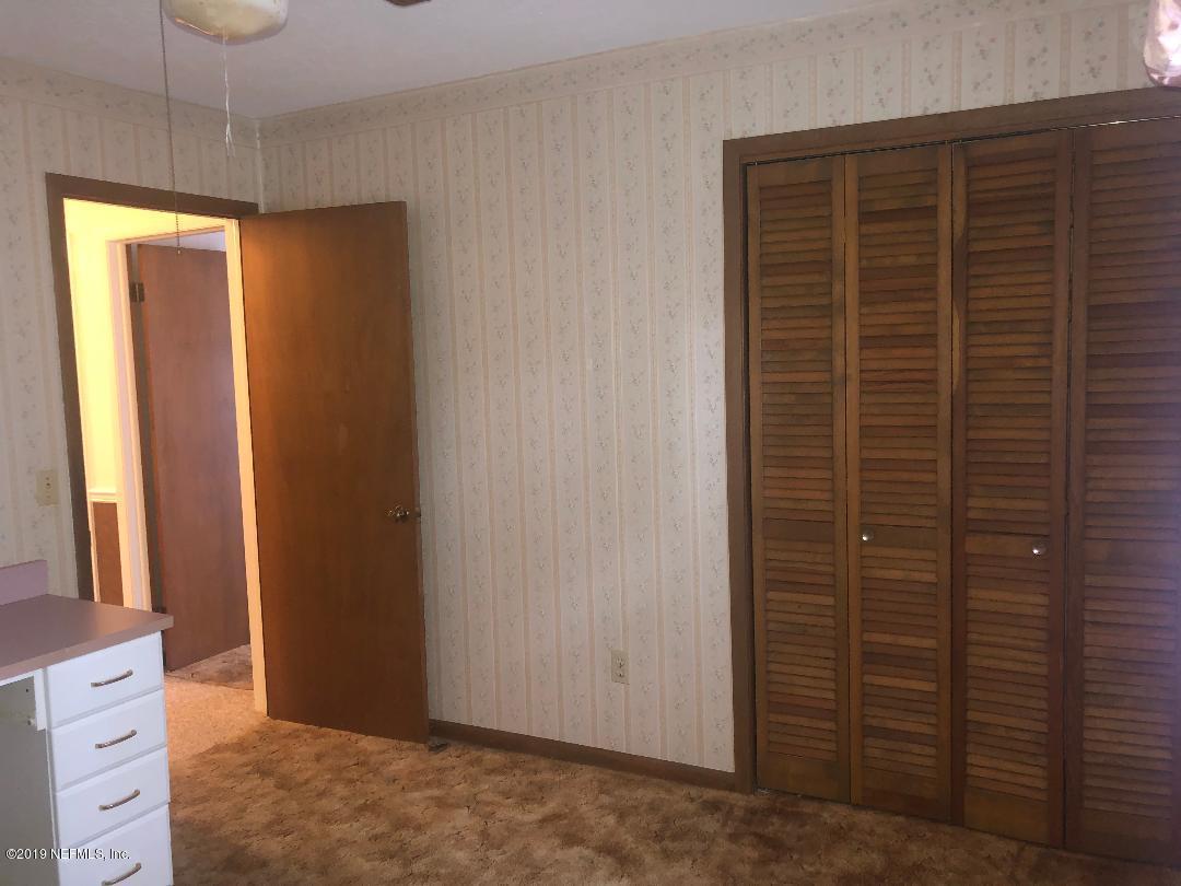 45142 Stratton Road Callahan, FL 32011 - Photo 18 of 29 a view of walk in closet with clothes