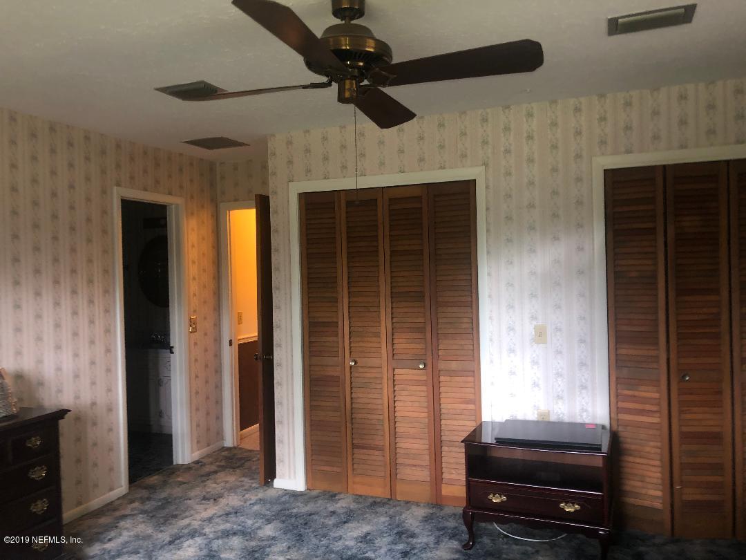 45142 Stratton Road Callahan, FL 32011 - Photo 26 of 29 a bedroom with a bed and a ceiling fan
