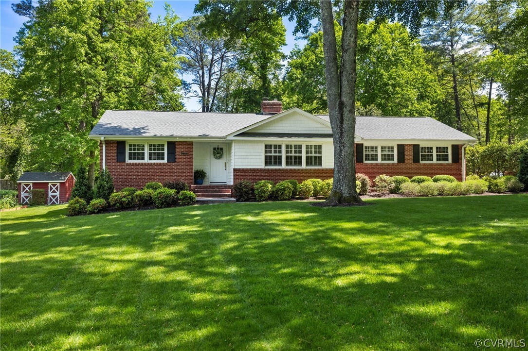 7658 Cherokee Road Richmond, VA 23225 - Photo 1 of 36 a front view of a house with a garden
