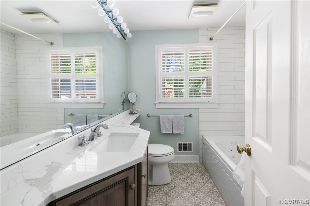 7658 Cherokee Road Richmond, VA 23225 - Photo 20 of 36 a bathroom with a sink a toilet and bathtub