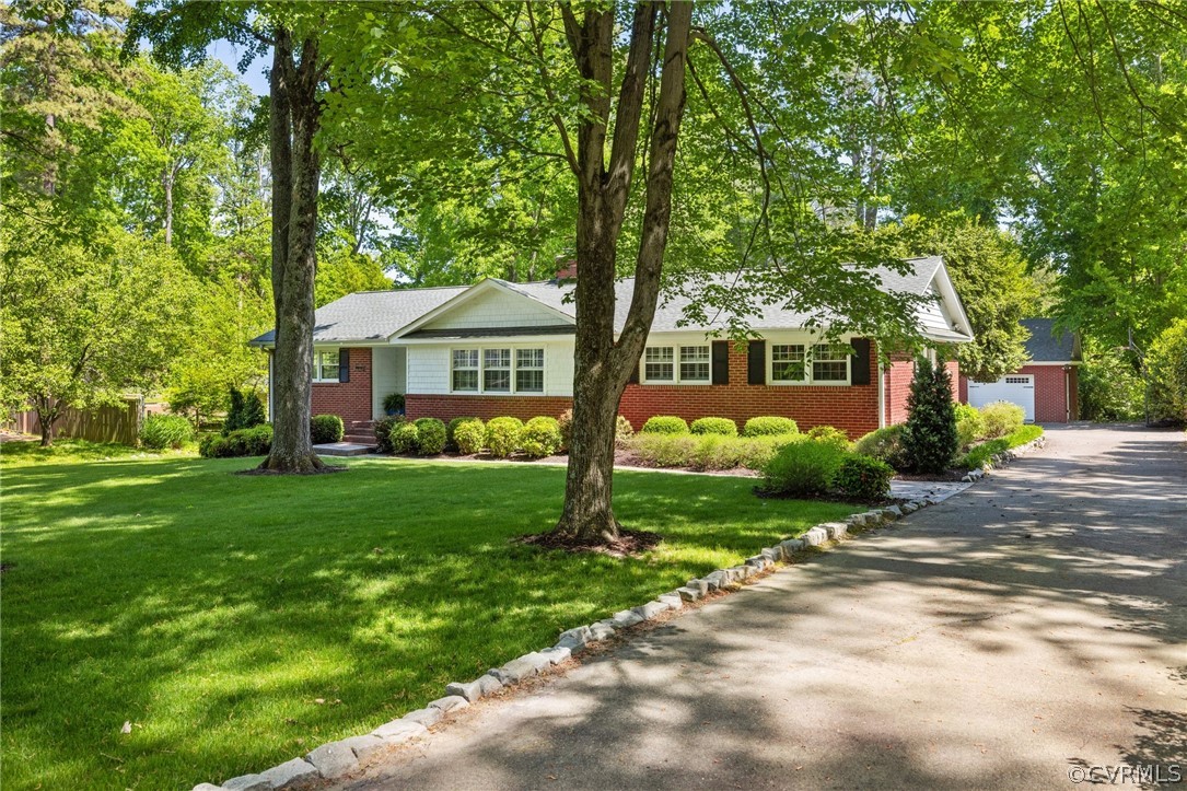 7658 Cherokee Road Richmond, VA 23225 - Photo 3 of 36 a front view of a house with garden
