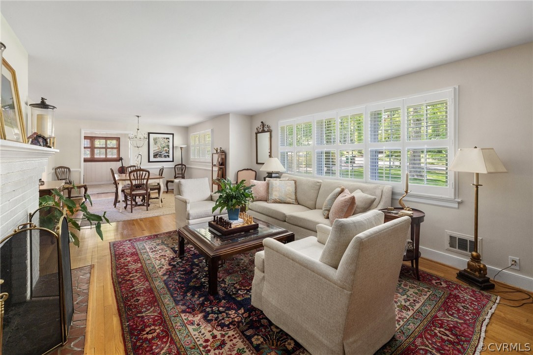 7658 Cherokee Road Richmond, VA 23225 - Photo 5 of 36 a living room with furniture large window and wooden floor