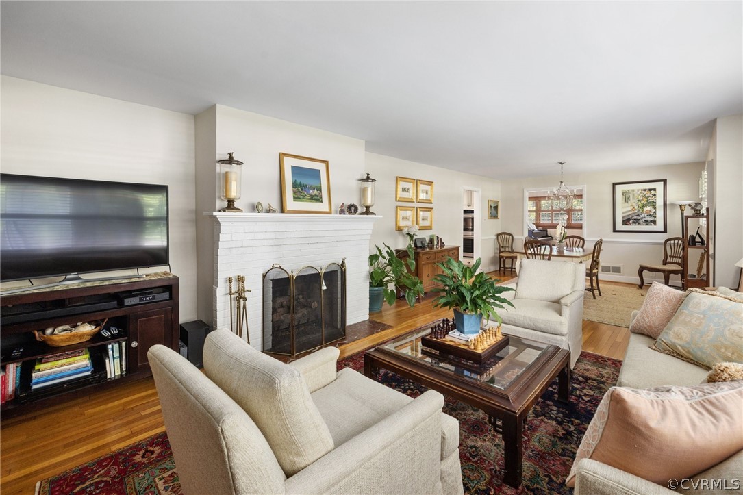 7658 Cherokee Road Richmond, VA 23225 - Photo 6 of 36 a living room with furniture a fireplace and a flat screen tv