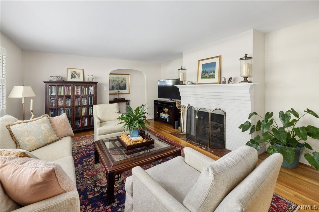 7658 Cherokee Road Richmond, VA 23225 - Photo 8 of 36 a living room with furniture flower pot and a fireplace