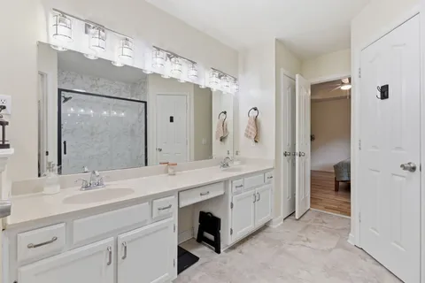 a spacious bathroom with a double vanity sink mirror and double