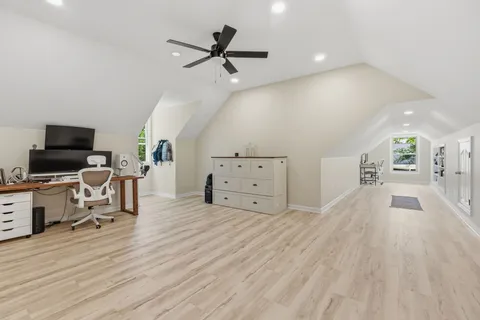 a view of a livingroom with hardwood floor and a ceiling fan