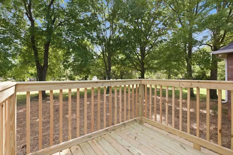 a balcony with wooden floor and fence
