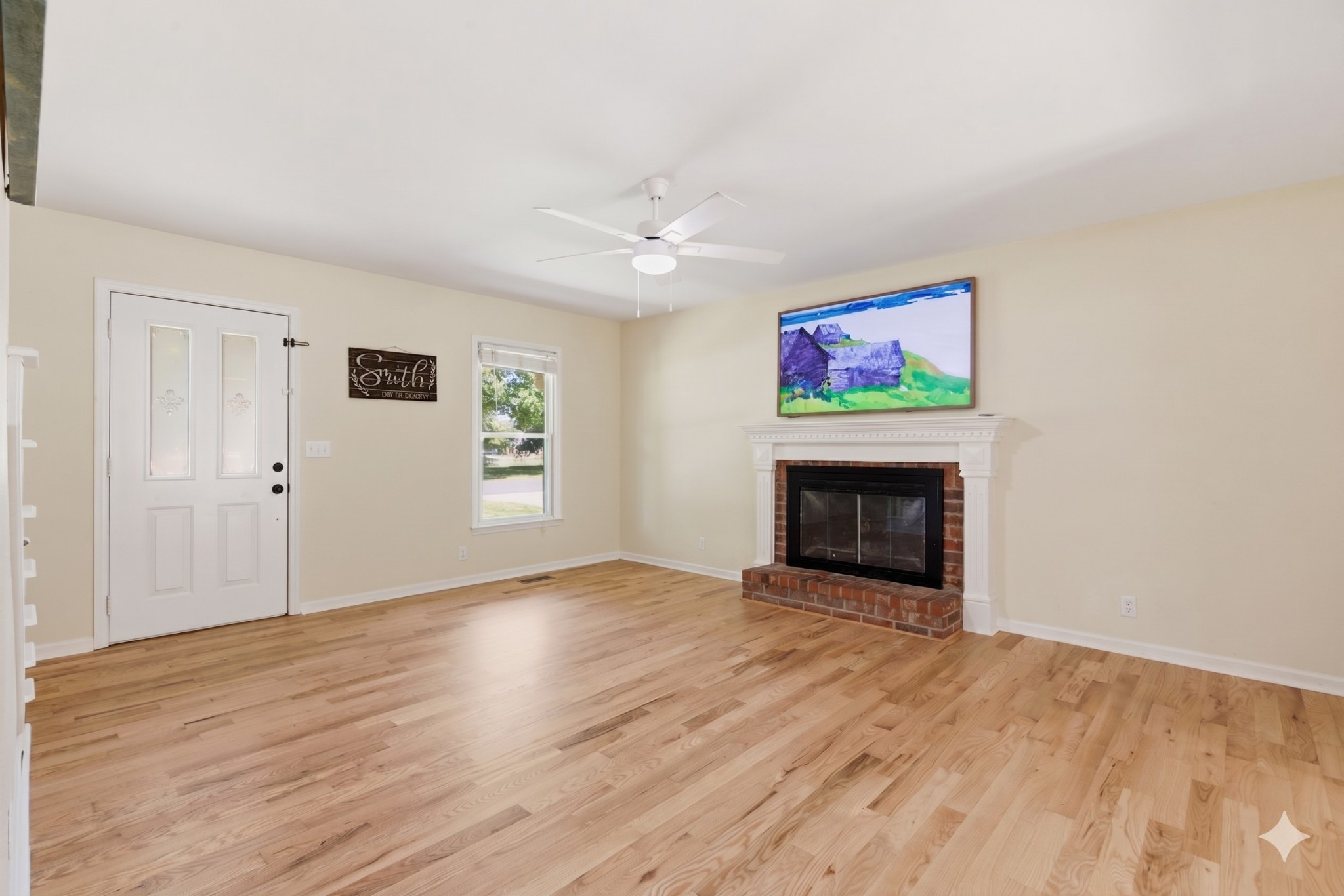 2306 Red Mile Road Murfreesboro, TN 37127 - Photo 8 of 43 a view of an empty room with wooden floor fireplace and a window