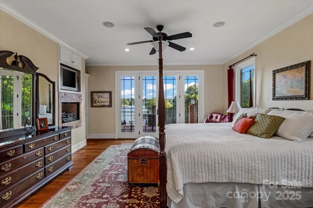 a bedroom with a bed and glass walk in closet
