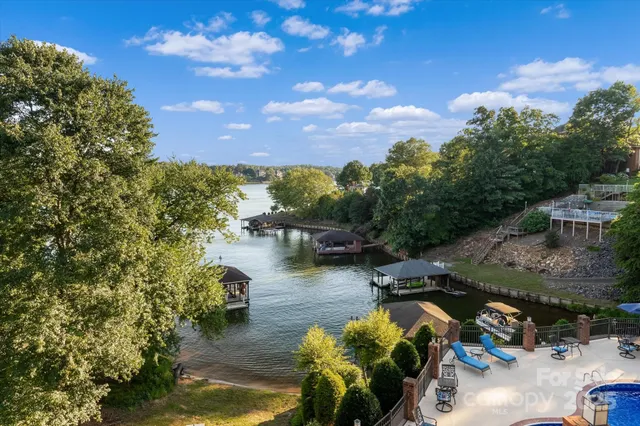 a view of a lake with lawn chairs