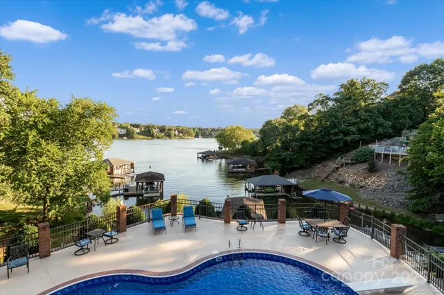 a view of a house with swimming pool and sitting area