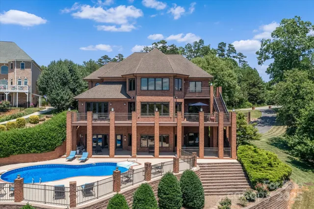a view of a patio with couches chairs and a table with potted plants