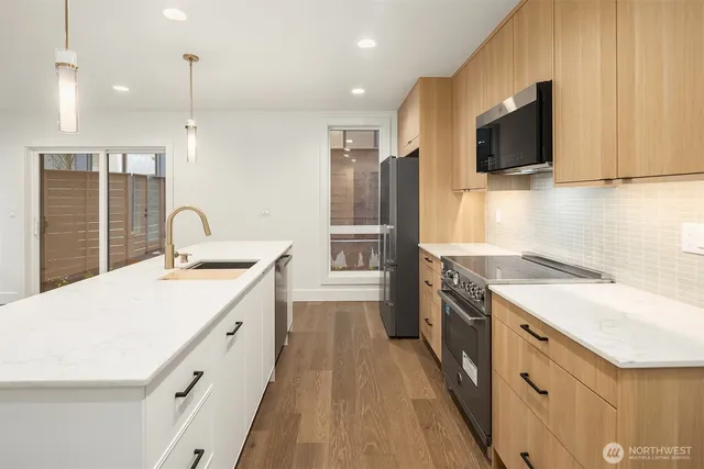 a kitchen with a sink stove and refrigerator