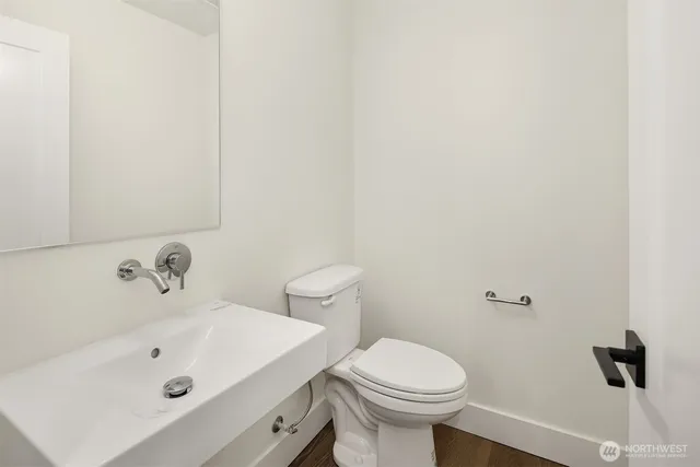 a bathroom with a sink a toilet and a mirror