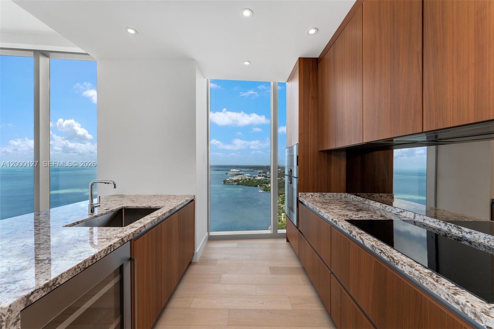 175 Southeast 25th Road, Unit 3602 Miami, FL 33129 - Photo 4 of 25 a kitchen with stainless steel appliances granite countertop a sink and a refrigerator