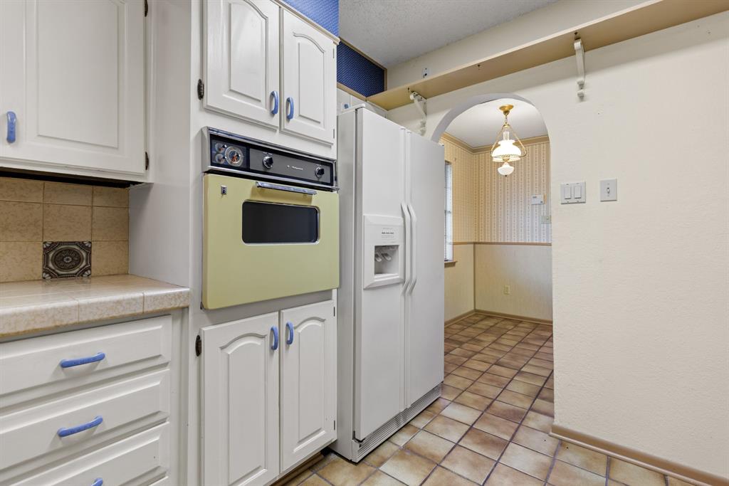 100 Linden Lane Hewitt, TX 76643 - Photo 11 of 31 a kitchen with stainless steel appliances a refrigerator and a stove top oven