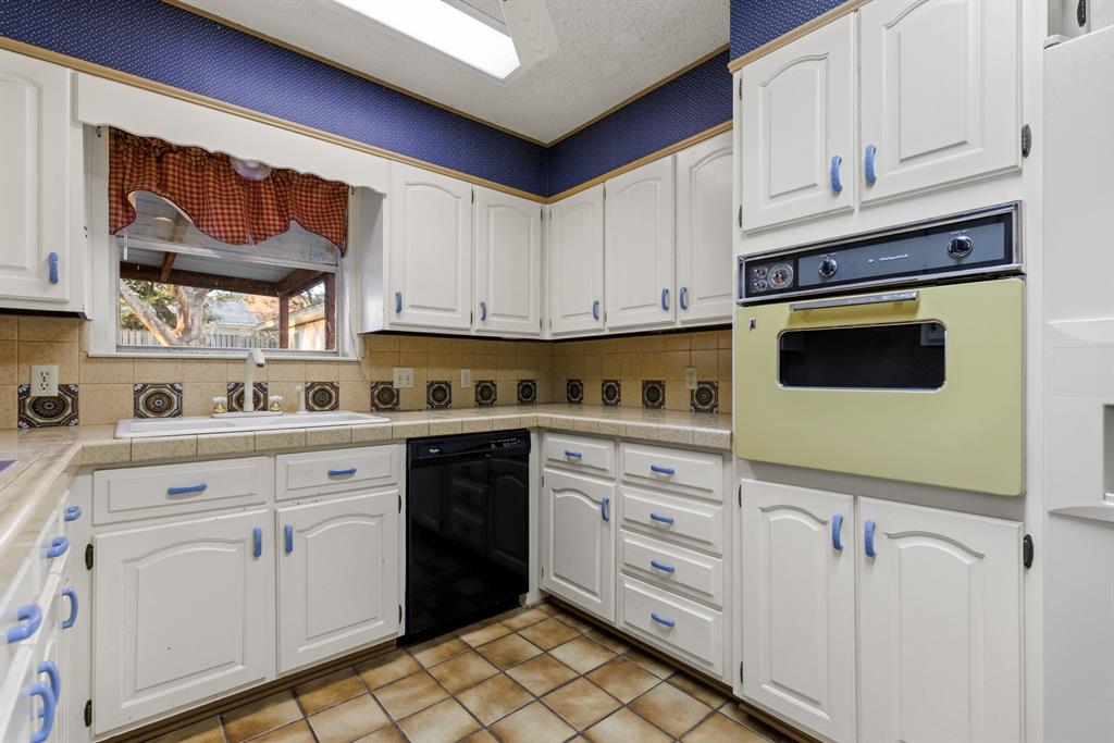 100 Linden Lane Hewitt, TX 76643 - Photo 10 of 31 a kitchen with white cabinets and white appliances
