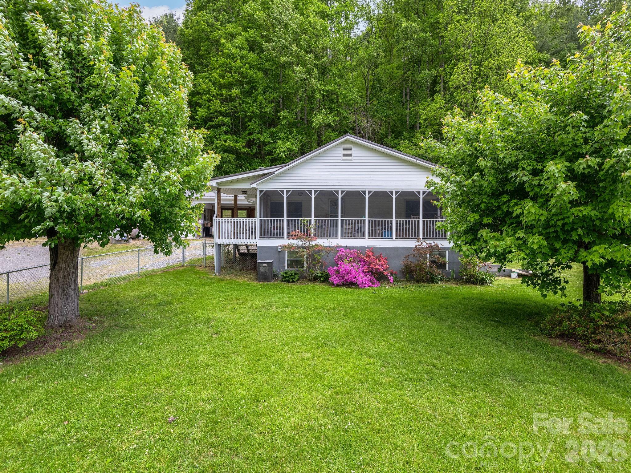 379 North Fork Road Barnardsville, NC 28709 - Photo 1 of 27 a front view of a house with a yard and trees