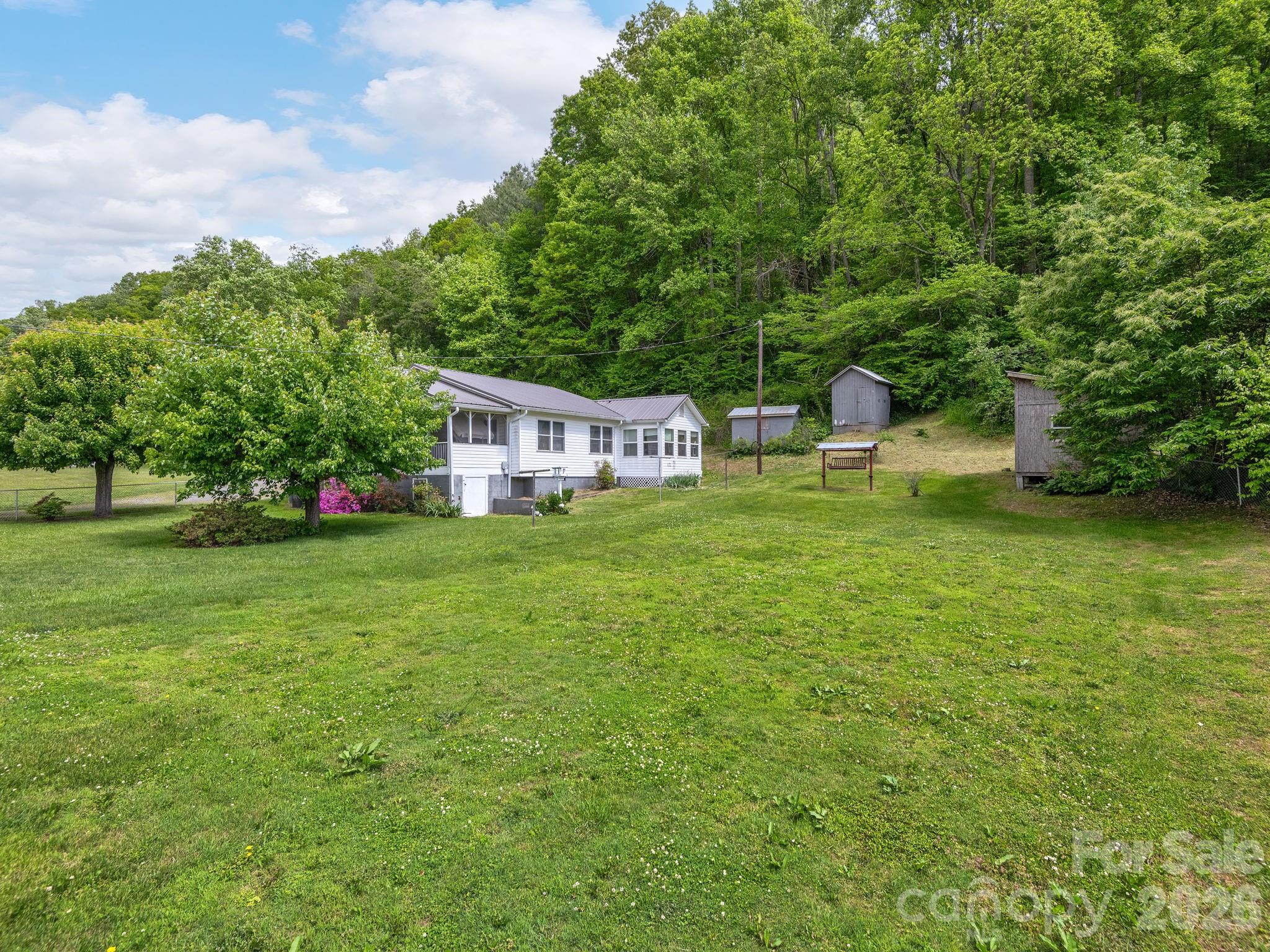 379 North Fork Road Barnardsville, NC 28709 - Photo 13 of 27 a view of house with backyard space and garden