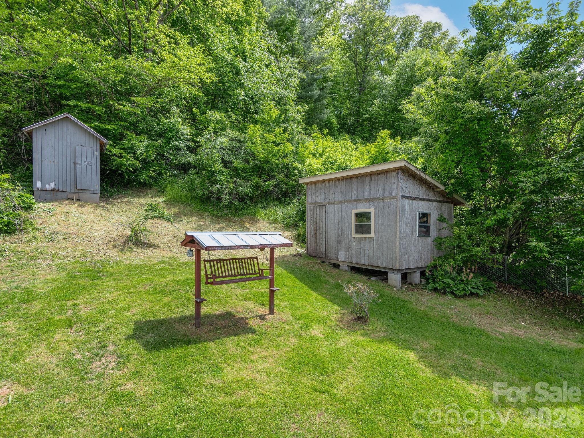379 North Fork Road Barnardsville, NC 28709 - Photo 15 of 27 a view of a backyard with table and a fence