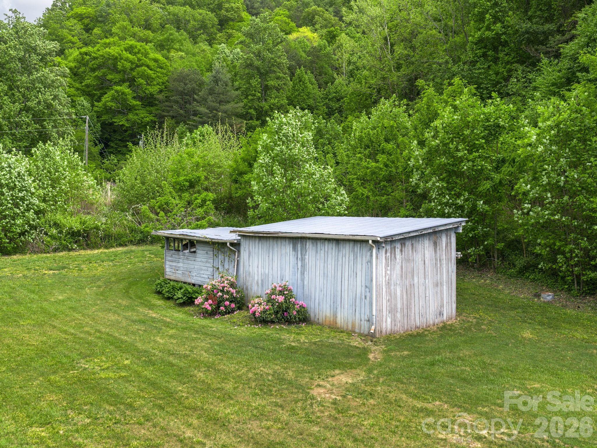 379 North Fork Road Barnardsville, NC 28709 - Photo 19 of 27 a backyard of a house with lots of green space