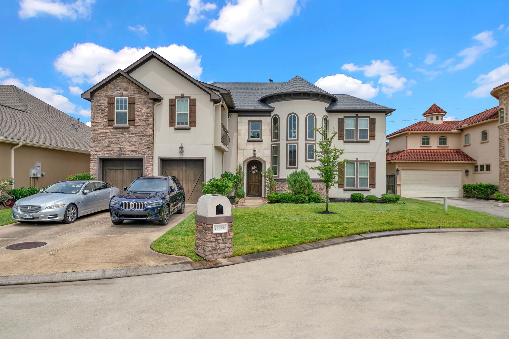 a front view of a house with a yard and garage