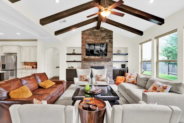a living room with lots of furniture and a flat screen tv