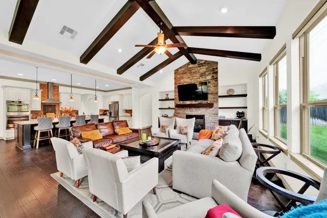 a living room with furniture and floor to ceiling windows