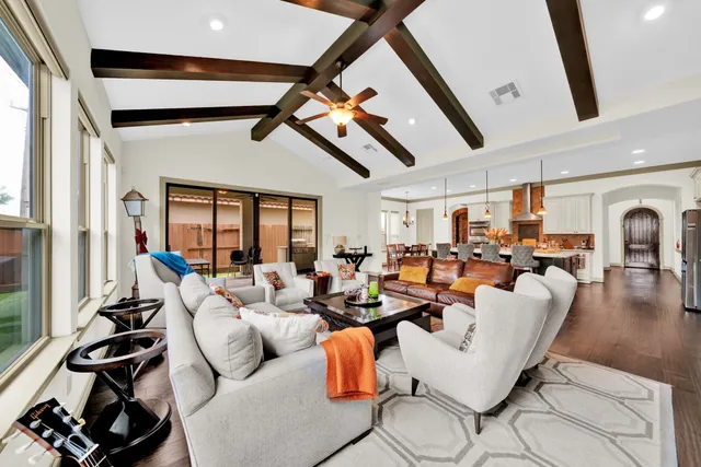a living room with granite countertop couches a fireplace with wooden floor