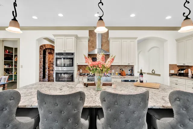 a view of dining room and livingroom with furniture wooden floor a chandelier