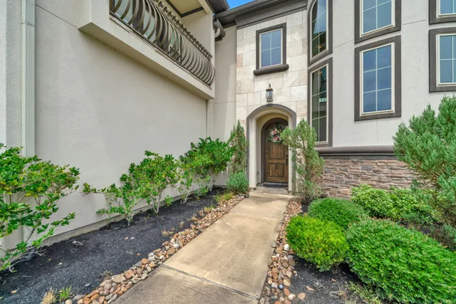 a front view of a house with a garden