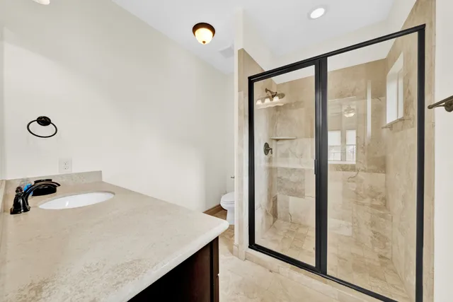 a spacious bathroom with a tub double sink and a mirror