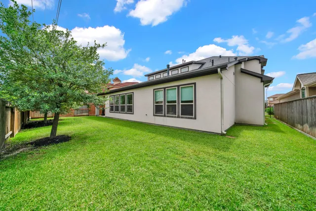 a yellow and white house sitting in the grass