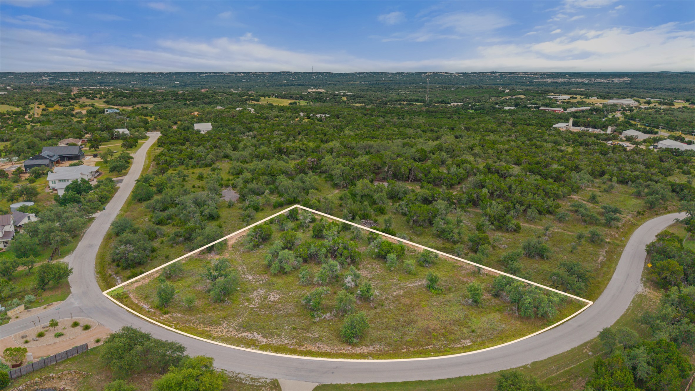 32000 Mirela Ann Road Dripping Springs, TX 78620 - Photo 3 of 12 A spacious, undeveloped lot with verdant foliage, offering endless possibilities for a custom build.